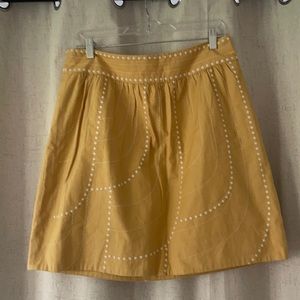 Anthropologie cute skirt. Mustard yellow with off white stitching.